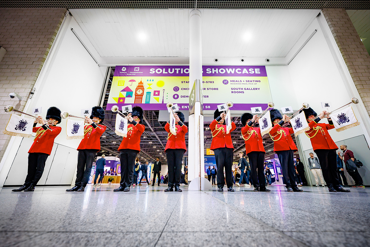 A brigade of Beefeaters blow brass instruments in front of the entrance to the Solutions Showcase exhibition hall